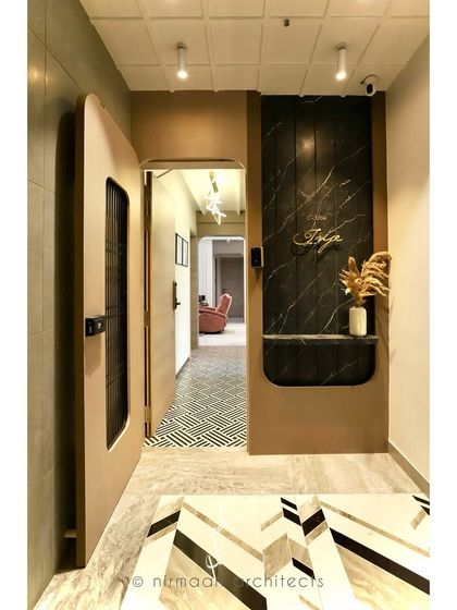 A peek from the main door into the 'Atmosphere' project. The geometric floor tiles in the passage lead you into the modern classic living room, creating a journey of discovery.