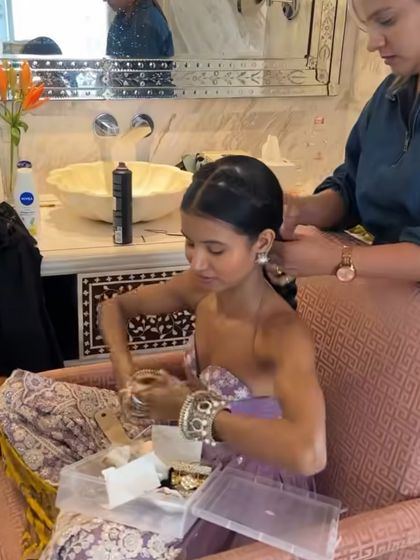 A behind-the-scenes moment styling influencer Nancy Tyagi. Here, I am creating the foundation for her intricate pearl-draped braid, showing the first steps of the process.