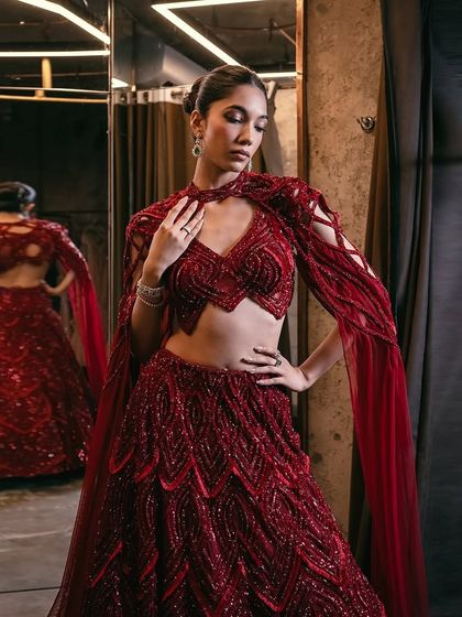 This crimson red lehenga can be transformed with a cape swap, taking you from wedding elegance to after-party glamour.