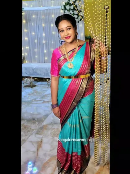 Another shot of Arpita at her baby shower. The drape is secure and stylish, allowing her to enjoy her special day without any worries about the saree.