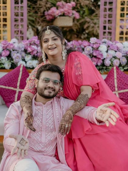 A lovely couple photo from the mehandi ceremony. The bride's hands are on the groom's shoulders, showing off her beautiful mehandi.