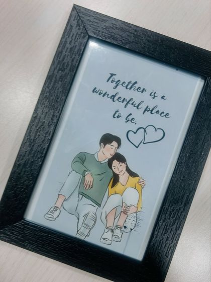 Celebrate your love story with a custom illustrated frame. This piece features a sweet drawing of a couple with the quote "Together is a wonderful place to be," making it a heartfelt and unique gift.