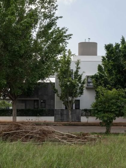 A wider view of the DUBEY Home, showing how it is situated among the trees of the neighborhood. Our design process always begins with a careful study of the site and its existing natural elements.