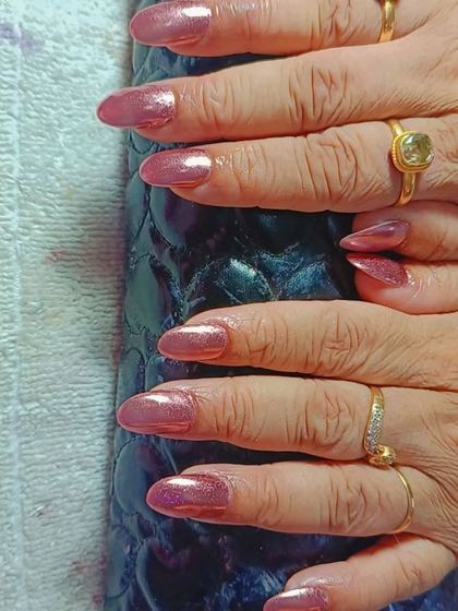 For a sleek and metallic look, I offer chrome finishes. These almond-shaped nails have a beautiful rose gold chrome effect that is both trendy and sophisticated.