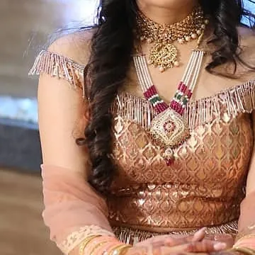 A close-up of the off-shoulder blouse, showing the intricate brocade fabric and tassel details. This modern design is perfect for a chic, contemporary ethnic look.