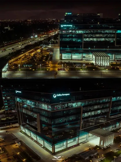 An identical high-quality night view of the Collins Aerospace building, captured with our Mavic 2 Pro drone to ensure sharp details and vibrant lighting.