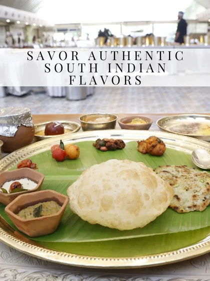 Our pride lies in authentic South Indian cuisine. This traditional meal, served on a banana leaf over a brass thali, features an assortment of classic dishes like pooris, chutneys, and sweets, offering a genuine taste of our heritage.