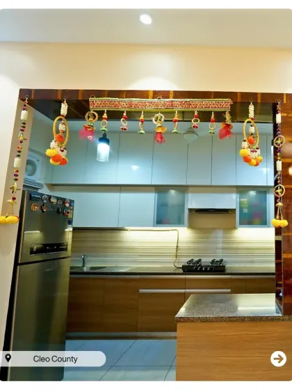 An open kitchen layout decorated for a celebration. The design features a breakfast counter and a mix of wood and white cabinets for a warm, inviting feel.