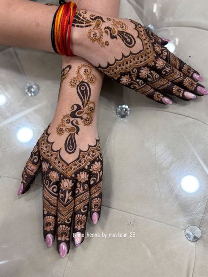 An elegant Arabic-style peacock design for Rakhi. The pattern flows beautifully from the fingers up the wrist.
