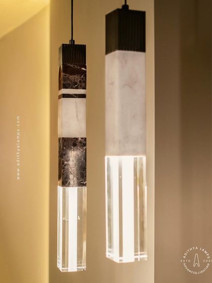 A collection of our pillar pendants, which combine sections of solid marble, fluted metal, and clear crystal. These substantial, high-quality fixtures can be hung individually or in clusters to create a dramatic effect in stairwells or entryways.