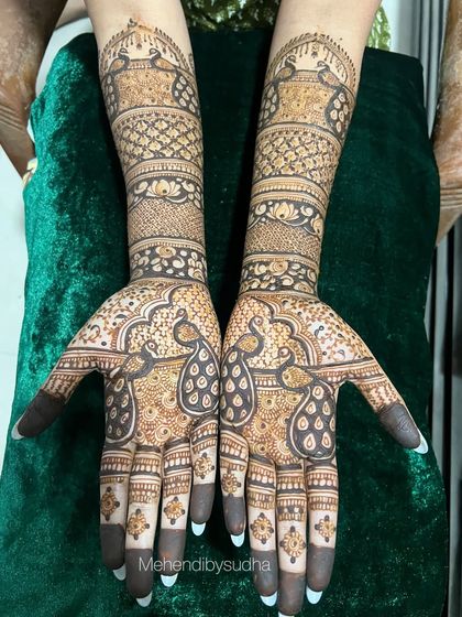 The same peacock engagement design against a rich green velvet background.