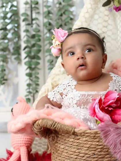 Pretty in pink and lace at three months old. This session uses soft textures and a floral headband to create a delicate and beautiful portrait of this baby girl.