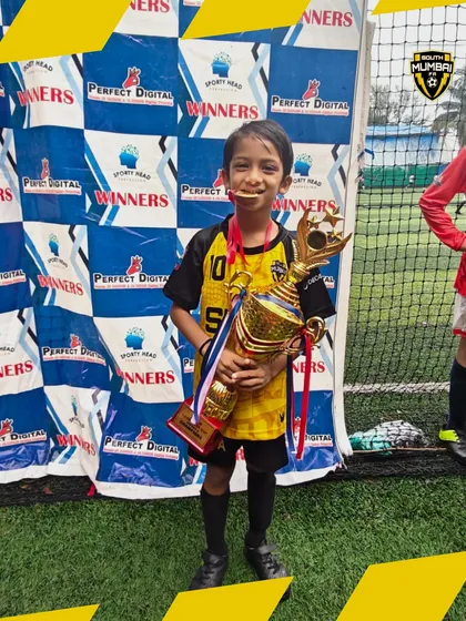 A smile of a champion. This U8 player's joy is a testament to the team's hard work and dedication.