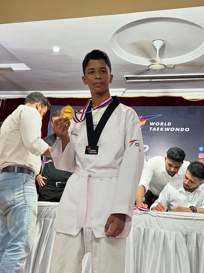 A young fighter from our team with his well-earned gold medal at the Taekwondo championship.