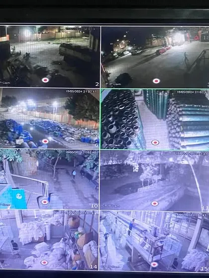 This is the central monitoring screen for a large-scale IP camera system at a factory in Faridabad. It shows 16 different feeds simultaneously, covering production floors, storage areas, and outdoor premises, even in low-light conditions.