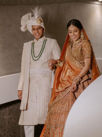 Another shot of the couple, capturing their smiles and the beautiful details of their outfits.