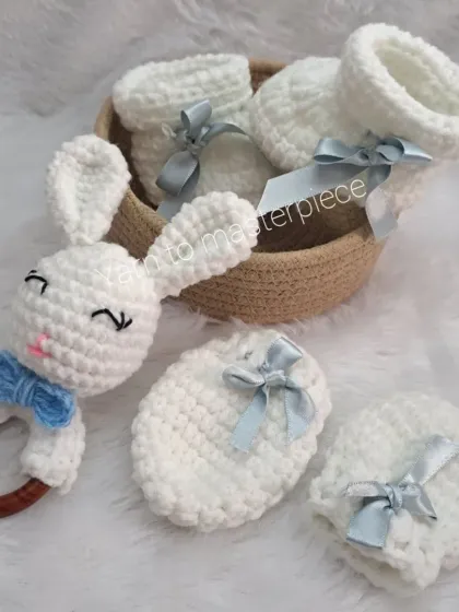 This is the baby boy version of my gift hamper, featuring a bunny rattle and matching booties and mittens with light blue satin ribbons.