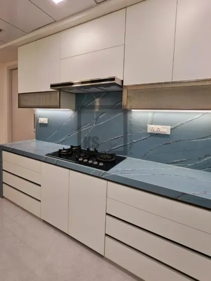 Your kitchen should reflect your personality. For this project, we used a bold blue marble-effect quartz for the countertop and backsplash, creating a stunning statement piece. Paired with clean white cabinetry, it proves that practical kitchens can also be incredibly stylish.