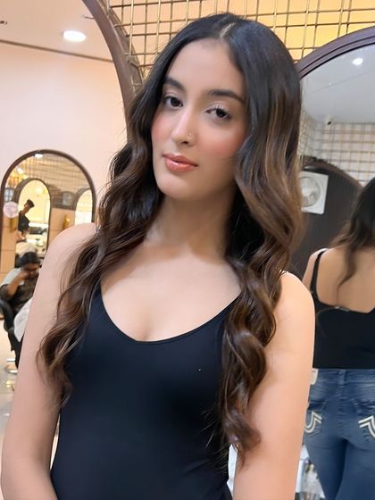 This angle showcases how the balayage highlights frame the face, brightening the client's features and adding a healthy glow.