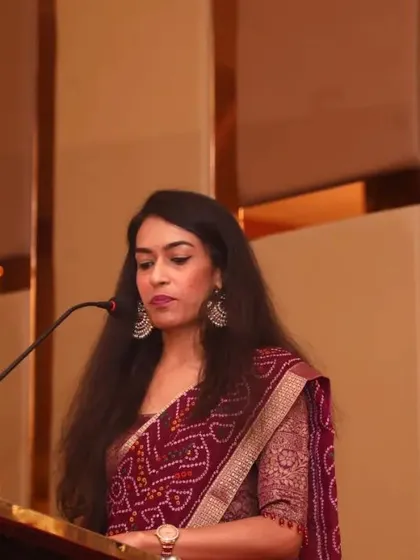 On stage at a formal corporate forum. I am just as comfortable commanding a stage for a keynote address or panel discussion as I am mingling at a sangeet.
