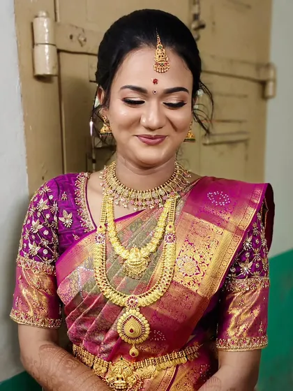 A beautiful engagement makeover with a magenta Kanjivaram saree and traditional gold jewelry.
