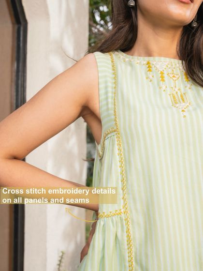 A close-up of the cross-stitch embroidery details on the panels and seams of our Suhani Mint Sleeveless Dress. These small touches highlight the meticulous craftsmanship of our artisans.