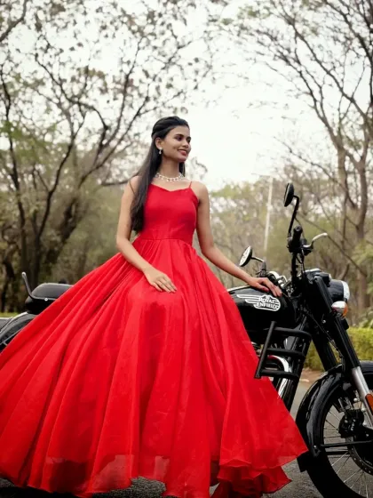 A modern princess moment. This stunning red ball gown paired with a motorcycle adds a cool, edgy vibe to a pre-wedding or solo photoshoot.