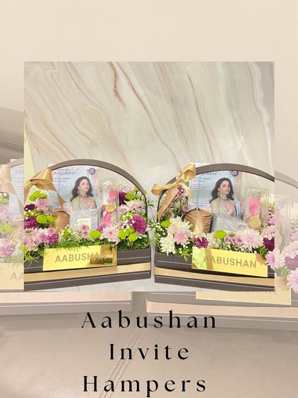 A stylized image of the Aabushan invite hampers, showcasing the beautiful floral arrangement and custom branding.