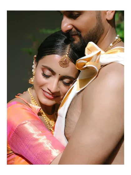 A quiet moment of togetherness. We specialize in capturing the serene and deep connection between a couple, like this tender embrace during a traditional South Indian wedding.