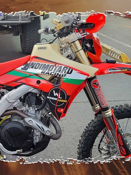 Another angle of our IndiMotard Racing bike, showing the custom graphics and navigation tower. This machine is built to withstand the toughest off-road race in the world.
