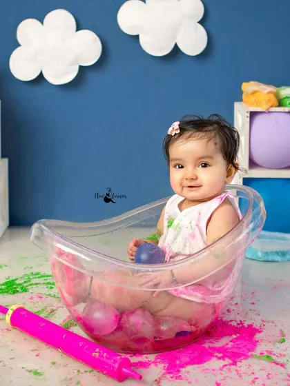 A post-play splash. Even the clean-up part is fun, as this little one enjoys a tub bath amidst the colors of Holi.