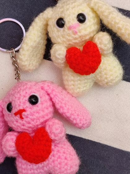 Adorable bunny keychains holding little red hearts, made for Valentine's but perfect for any time. I make them in brown, cream, pink, and purple.