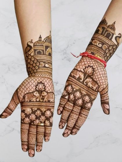 A beautiful blend of traditional motifs, this design includes elephants, lotuses, and palace architecture, symbolizing prosperity, purity, and a new home.