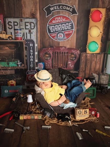 For the little boy who's ready to take on the world. This vintage garage theme is perfect for a baby boy's newborn shoot, complete with tools, signs, and a tiny traffic light.