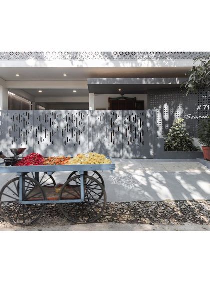 The context of the street brings the architecture to life. A flower vendor's cart adds a splash of color against the monochromatic palette of the '10x10 Residence' facade.