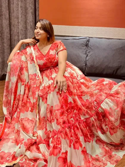 Our client looking radiant in the red and mint floral organza gown. The lightweight fabric and vibrant print make it a comfortable yet show-stopping choice for any celebration.