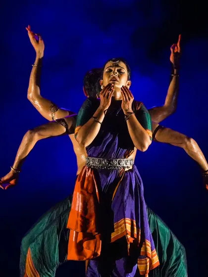 This image from 'Nagamandala' creates a multi-armed illusion, a visual representation of divinity often seen in Indian iconography.