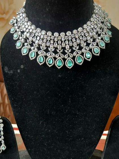 An elegant American Diamond necklace set with mint-green stones, perfect for a pastel-themed event.
