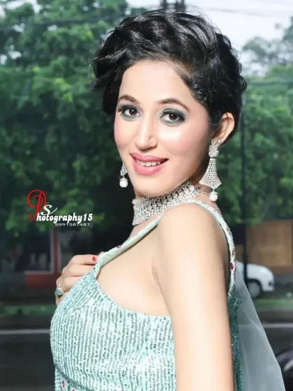 A close-up of a model in a light sea-green lehenga. The sequined blouse and simple diamond choker create a fresh and modern party look.