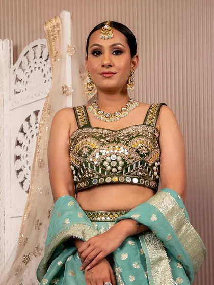 A beautiful client in a light blue and green lehenga with mirror work. This is a fantastic choice for a sangeet, reflecting the lights as you dance the night away.
