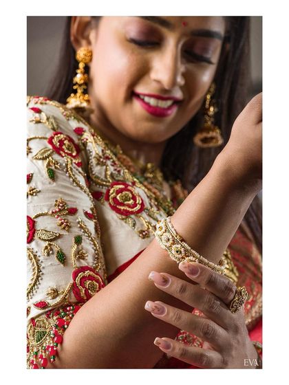 A duplicate of the previous detailed shot, emphasizing the texture and artistry of the bridal blouse and jewellery for commercial use.