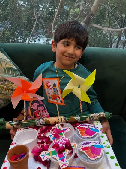 A proud student with his fully loaded Holi platter, ready to celebrate the festival of colors.