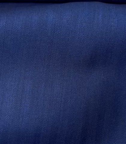 A deep blue herringbone fabric. The subtle pattern adds texture and visual interest to a classic blue blazer or suit.