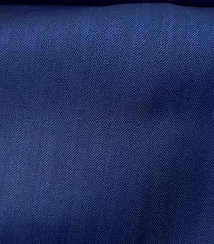 A deep blue herringbone fabric. The subtle pattern adds texture and visual interest to a classic blue blazer or suit.