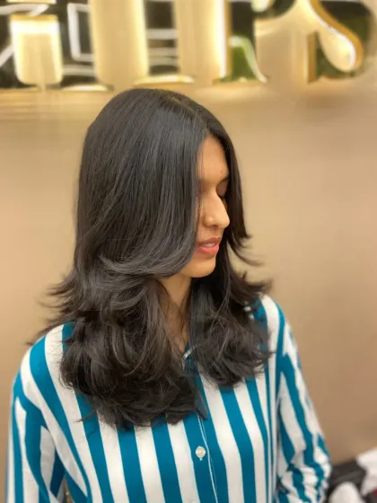 A side view of a layered haircut, showing how the layers are angled to create a beautiful, flowing shape.
