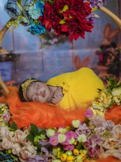 A full view of the beautiful floral swing setup, showing the vibrant colors and dreamy backdrop.