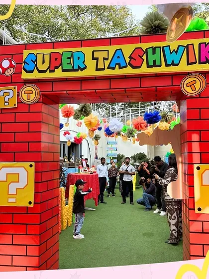 The grand entrance to Super Tashwik's Mario-themed birthday. The brick archway and question mark blocks immediately transport guests into the world of the beloved video game.