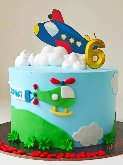 Up, up, and away! This airplane and helicopter-themed cake is perfect for a young aviation enthusiast's 6th birthday. The bright blue sky and fondant clouds create a cheerful backdrop for the edible vehicles.