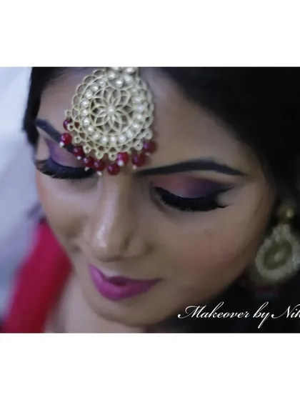 A close-up of Namratha's minimal and natural mehendi makeup. The focus is on a dramatic purple smokey eye and a matching lip color.