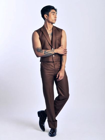 A modern take on classic tailoring. The sleeveless vest gives this suit a contemporary, fashion-forward edge.